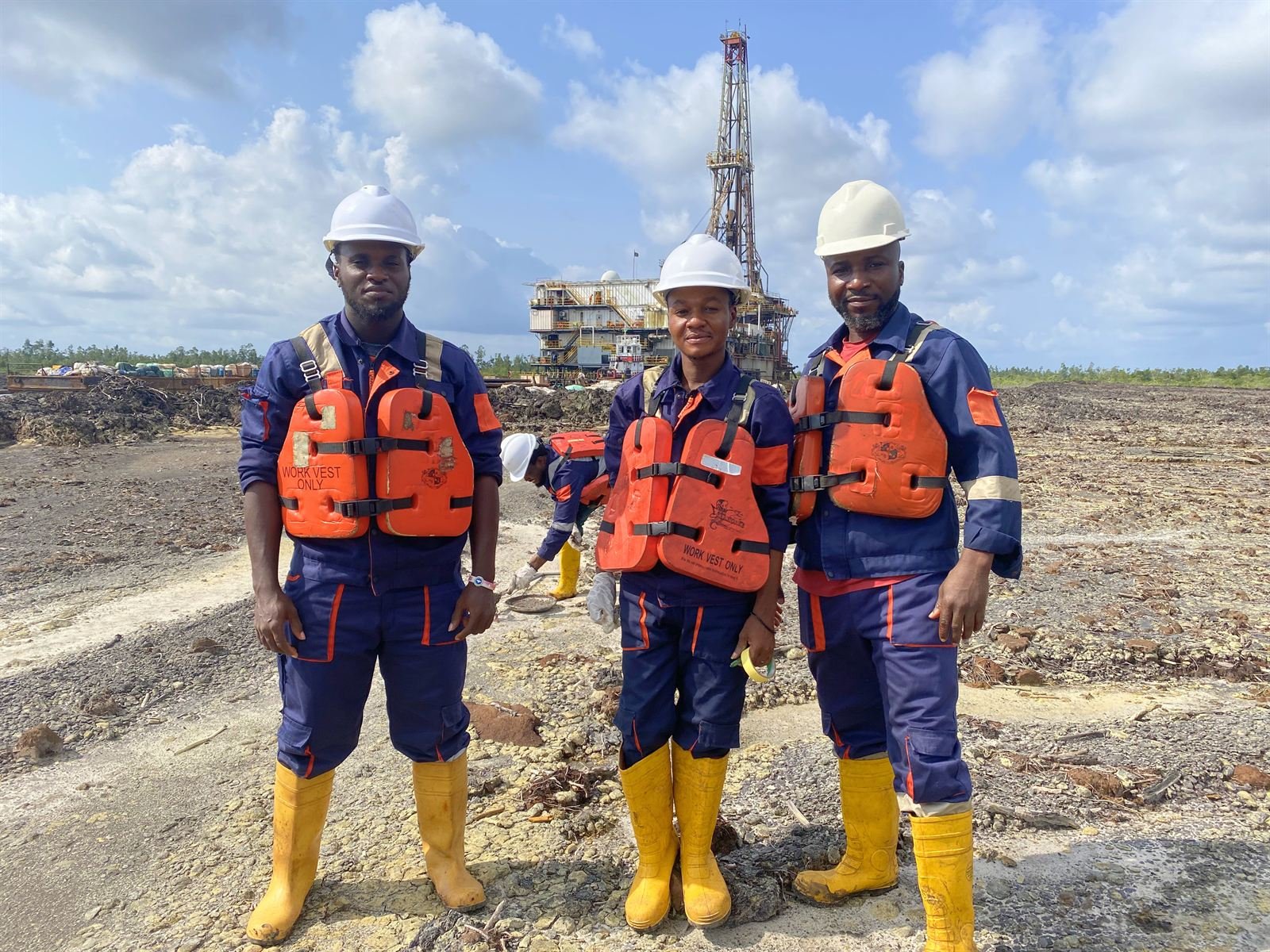 Three Quatenary field engineers at a drilling location